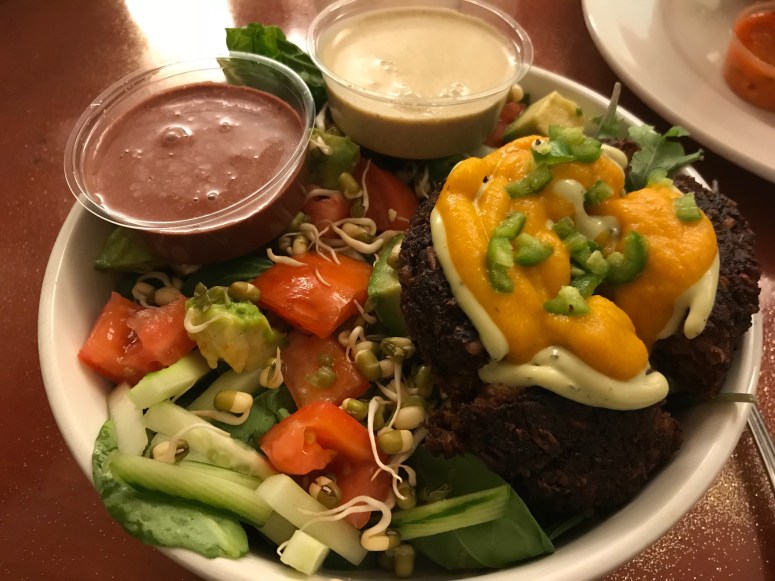 Bramha Salad topped with a fire burger